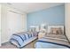 Bedroom with matching twin beds, modern decor, carpet, and a closet with sliding doors at 321 Auburn Ave, Kissimmee, FL 34747