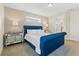 Bedroom featuring a tufted navy bed frame, carpet, and lots of natural light at 321 Auburn Ave, Kissimmee, FL 34747
