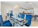 Dining room with a glass table, seating for eight, and an elegant chandelier at 321 Auburn Ave, Kissimmee, FL 34747