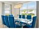 Dining room features a glass table with seating for eight and modern chandelier at 321 Auburn Ave, Kissimmee, FL 34747