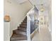 Inviting entryway with dark wood stairs, tiled floor, and stylish decor leading to the home's interior at 321 Auburn Ave, Kissimmee, FL 34747