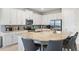 Bright kitchen with a large island, seating, white cabinetry, and stainless steel appliances, ideal for modern living at 321 Auburn Ave, Kissimmee, FL 34747