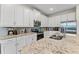 Well-equipped kitchen features stainless steel appliances, granite countertops, and white cabinets at 321 Auburn Ave, Kissimmee, FL 34747
