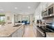 Open-concept kitchen featuring a large island, stainless steel appliances, and view into the dining area, perfect for gatherings at 321 Auburn Ave, Kissimmee, FL 34747