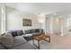Spacious living room with a gray couch, coffee table and carpet at 321 Auburn Ave, Kissimmee, FL 34747