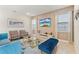Living room with comfortable seating, stylish decor, and a large screen television at 321 Auburn Ave, Kissimmee, FL 34747