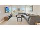Comfortable living room featuring a sectional sofa and a large screen television at 321 Auburn Ave, Kissimmee, FL 34747