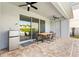 Outdoor patio area with dining table and stainless steel mini-refrigerator at 321 Auburn Ave, Kissimmee, FL 34747