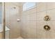 Tiled shower with brushed bronze fixtures and a built-in soap dish at 321 Auburn Ave, Kissimmee, FL 34747