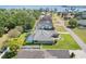 An aerial view of the neighborhood, showcasing the home with a screened pool and proximity to a lake at 5144 Riverlake Dr, Bartow, FL 33830