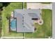 Aerial view showcasing the roof, large pool, well-maintained landscaping and circular driveway with a fountain feature at 5144 Riverlake Dr, Bartow, FL 33830