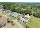 An aerial shot of the tennis court and well-maintained home in a neighborhood with mature tree coverage at 5144 Riverlake Dr, Bartow, FL 33830