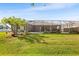 A spacious backyard featuring a screened enclosure with a well-maintained lawn at 5144 Riverlake Dr, Bartow, FL 33830