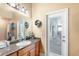 Bright bathroom with granite countertops, wood cabinets, and access to the patio at 5144 Riverlake Dr, Bartow, FL 33830