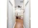 Hallway view of a bathroom with hardwood floors, double vanity, and a tile surround soaking tub at 5144 Riverlake Dr, Bartow, FL 33830