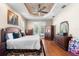 Bedroom with hardwood floors, ceiling fan, and french doors overlooking the pool at 5144 Riverlake Dr, Bartow, FL 33830