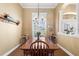 Dining room with wood floors, decorative chandelier, and natural light at 5144 Riverlake Dr, Bartow, FL 33830
