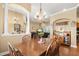 An elegant dining room featuring wood floors that opens to the living room at 5144 Riverlake Dr, Bartow, FL 33830
