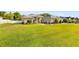 Charming single-story home featuring stone accents, a well-manicured lawn, and a circular driveway with a central fountain at 5144 Riverlake Dr, Bartow, FL 33830
