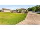 Single-story home with well-maintained lawn and landscaping, featuring stone accents, arched windows, and a paved driveway at 5144 Riverlake Dr, Bartow, FL 33830