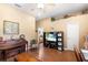 Cozy living room featuring a piano, entertainment center, and neutral-toned walls at 5144 Riverlake Dr, Bartow, FL 33830