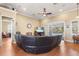 Cozy living room with a large leather sectional and ceiling fan at 5144 Riverlake Dr, Bartow, FL 33830