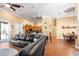 Open-concept living area featuring hardwood floors and a comfortable leather sectional at 5144 Riverlake Dr, Bartow, FL 33830