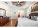 Spacious main bedroom with hardwood floors, ceiling fan and large dresser at 5144 Riverlake Dr, Bartow, FL 33830