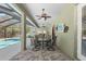 Covered patio with a dining set, perfect for outdoor entertaining by the pool at 5144 Riverlake Dr, Bartow, FL 33830
