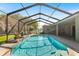 Beautiful pool featuring clear water, a spa, and landscaped surroundings, all within a screened enclosure at 5144 Riverlake Dr, Bartow, FL 33830