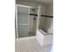 Elegant bathroom featuring a walk-in shower and tub with black and white tiled accents at 5580 Hwy 542 W, Winter Haven, FL 33880
