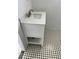 Bathroom vanity featuring a marble countertop, white cabinetry, open shelf and decorative tile flooring at 5580 Hwy 542 W, Winter Haven, FL 33880