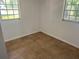 Bright room featuring tile flooring, a fresh coat of paint, and natural light from the two windows at 5580 Hwy 542 W, Winter Haven, FL 33880
