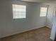 This bedroom features tile flooring, two windows with mini blinds and is freshly painted at 5580 Hwy 542 W, Winter Haven, FL 33880