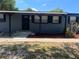 Home featuring a covered porch and brick walkway that enhances its welcoming feel at 5580 Hwy 542 W, Winter Haven, FL 33880
