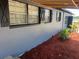 Charming home showcasing decorative shutters with red mulch in landscaped yard at 5580 Hwy 542 W, Winter Haven, FL 33880