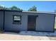 A well-maintained detached structure with a door and window at 5580 Hwy 542 W, Winter Haven, FL 33880