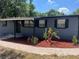 Charming home featuring dark shutters and colorful landscaping, enhancing curb appeal at 5580 Hwy 542 W, Winter Haven, FL 33880