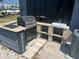 Outdoor kitchen with sink, gas grill, granite countertops, and paver flooring at 5580 Hwy 542 W, Winter Haven, FL 33880