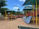 Colorful community playground with slides, climbing areas, and shaded canopies for comfortable play at 5580 Hwy 542 W, Winter Haven, FL 33880