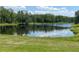Scenic pond surrounded by lush greenery, reflecting the sky for a tranquil community view at 5580 Hwy 542 W, Winter Haven, FL 33880
