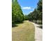 Inviting community walking path surrounded by lush trees and manicured lawns at 5580 Hwy 542 W, Winter Haven, FL 33880