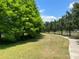 Scenic walking path surrounded by lush greenery and mature trees, perfect for outdoor exercise at 5580 Hwy 542 W, Winter Haven, FL 33880