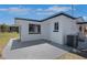 Rear exterior showing the home's patio with white cinder block, windows and door at 1475 3Rd Ave, Deland, FL 32724