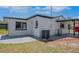 Rear exterior featuring a white cinder block home with a patio, air conditioner, and tank at 1475 3Rd Ave, Deland, FL 32724