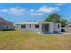 Exterior rear of house featuring metal roof and an expansive backyard at 1475 3Rd Ave, Deland, FL 32724