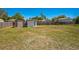 Large backyard with a brown and white storage shed, all enclosed by a wooden fence at 1475 3Rd Ave, Deland, FL 32724