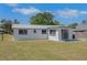 Exterior rear of house featuring metal roof and an expansive backyard at 1475 3Rd Ave, Deland, FL 32724
