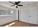 Cozy bedroom with wood-look floors, a ceiling fan, and a bright window at 1475 3Rd Ave, Deland, FL 32724