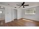 Bedroom with hardwood floor, ceiling fan, and open closet at 1475 3Rd Ave, Deland, FL 32724